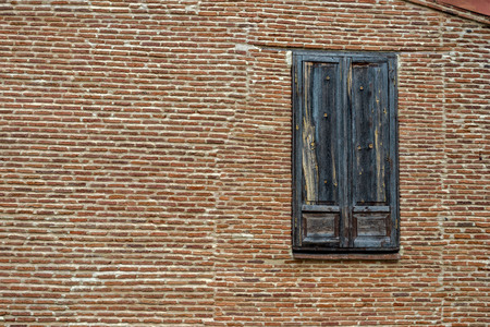 An old wooden door in the middle of a brick wall.の写真素材
