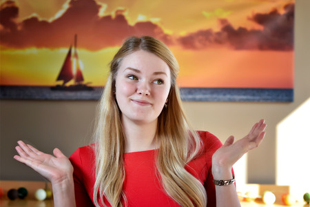 Surprised blonde woman in a red dress.の写真素材