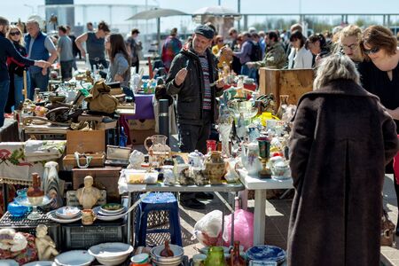 RIGA, LATVIA - MAY 12, 2017: People walk around the old things market and look at the goods.のeditorial素材