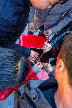 BEIJING, CHINA - MARCH 10, 2016: Worshippers ignite the incense sticks at Yonghegong Lama Temple in Beijing, China.のeditorial素材
