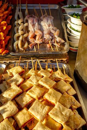 Exotic snacks and desserts can be found in this famous market Donghuamen Night food market near Wangfujing street, Beijing, Chinaの写真素材