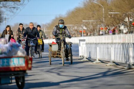 BEIJING, CHINA - MARCH 10, 2016: There are many different motorcycles and bicycles on the streets of the Beijing. With motorcycles transporting people, goods, building materials and much more.のeditorial素材