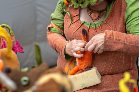 Woman handmade soft felted toys in front of viewers.の写真素材