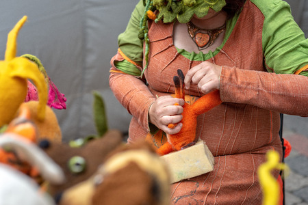 Woman handmade soft felted toys in front of viewers.の写真素材