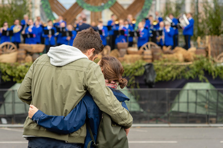 A young couple are watching a concert. View from the back.の写真素材