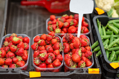 Boxes of strawberries and peas of new peas.の写真素材
