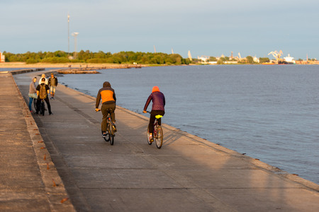 At sunset on the mole people cycling and walking.のeditorial素材