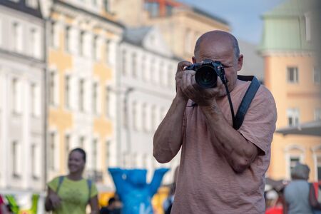 RIGA, LATVIA - JULY 26, 2018: United Buddy Bears exhibition. A man with a camera photographs the performance of the exhibition.のeditorial素材