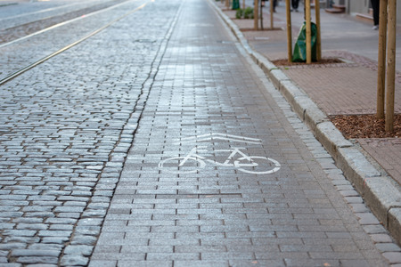 Cobbled street with tram rails and separate lanes for cyclists.の写真素材