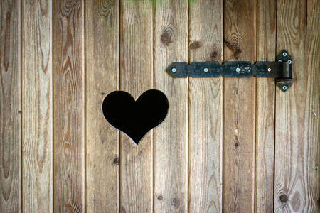 Wooden outdoor toilet with heart on the door.の写真素材