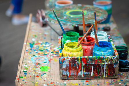 Containers with different colors the artist's outdoor workshop.の写真素材