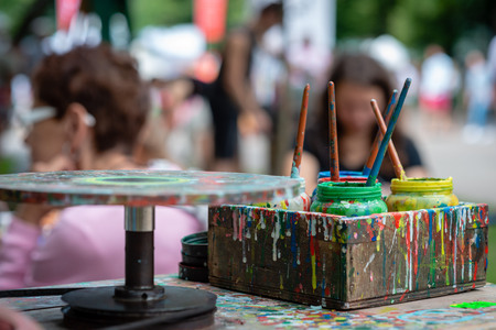Containers with different colors the artist's outdoor workshop.の写真素材