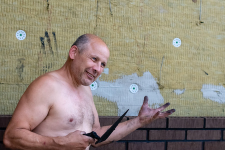 A bricklayer tells about his work showing instruments.の写真素材