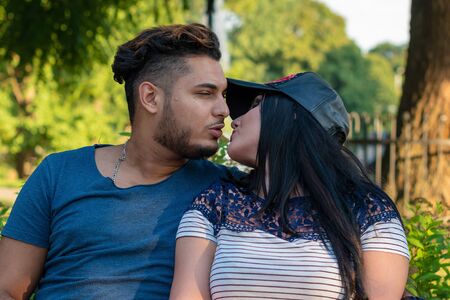 RIGA, LATVIA - JULY 26, 2018: Young couple in love kissing in the park.のeditorial素材