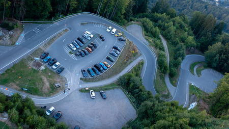 Evening view from observation tower Pyramidenkogel to the parking lot and the mountain serpentine,...