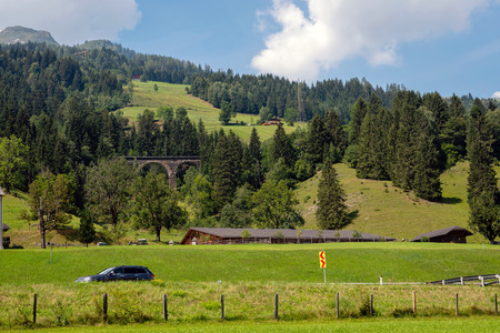 A picturesque Alpine landscape with an old railway bridge. Austria.の写真素材