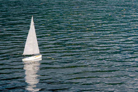 White sailing yacht model floating in the lake.の写真素材