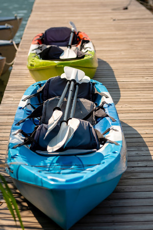 Boats and paddles on the lake footbridge.の写真素材