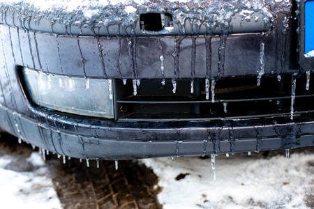 Car on the street covered by icy rain.の写真素材