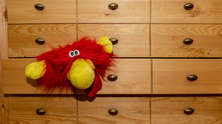 A carnival mask is visible from the chest of drawers.の写真素材