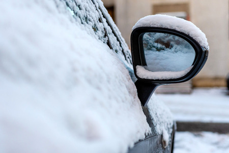 Close-up of snow covered car wing mirror.の写真素材