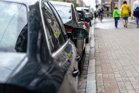 Typical urban landscape. Rear view of cars parked near the  street with soft-focus in the background...
