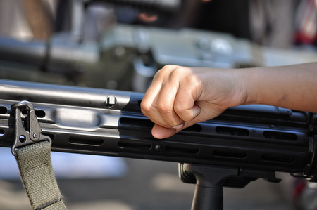 The hand of a child on the crank of a weapon switch mechanism - imageの写真素材