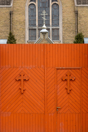 Church fence wooden gate in orange with crosses - imageの写真素材