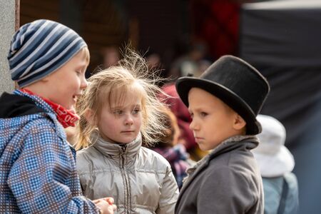 RIGA, LATVIA - MAY 4, 2019:  Festive concert in the city park. Children in ancient national clothing