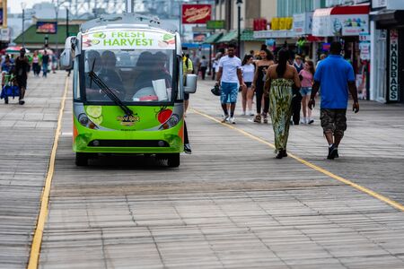 ATLANTIC CITY, NEW JERSEY - JUNE 18, 2019: Tourists walk on the  2.5 miles long boardwalk in...