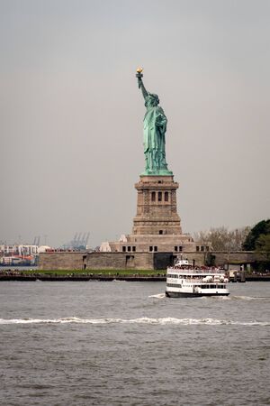 New York, USA - June 7, 2019: Ferry Boat approaching the Statue of Liberty, Liberty Island - Imageのeditorial素材