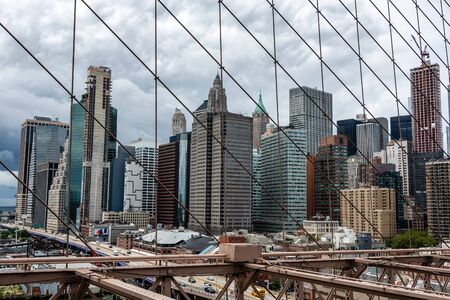 New York, USA - June 21, 2019:  Manhattan through the Brooklyn Bridge metal ropes.のeditorial素材