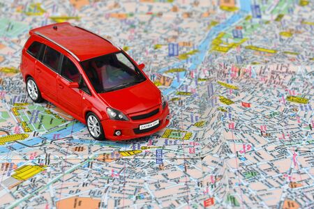 Close-up of a red car on a tourist map background. The concept of car tourism.の写真素材