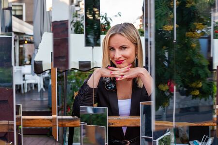 Portrait of a young, emotional, blonde woman through the installation of mirror.の写真素材