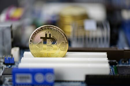 Golden Cryptocurrency coins on computer circuit board, selective focus  - image