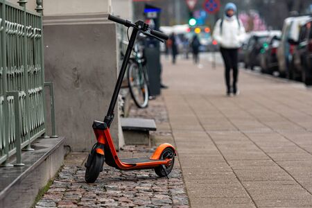 An electric scooter parked on the sidewalk in Riga, Latvia - imageの写真素材