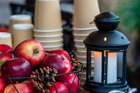 Glowing candle lantern and basket of apples on the table in the Christmas Market in Riga, Latvia, selective focus - imageの写真素材