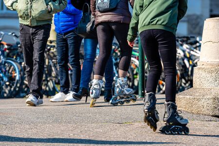 Geneva, Switzerland - April 14, 2019: teenager roller skating on city street, closeup of legs - imageのeditorial素材