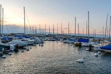 Geneva, Switzerland - April 14, 2019: View of Geneva City and Lake Geneva Port after sunset - image