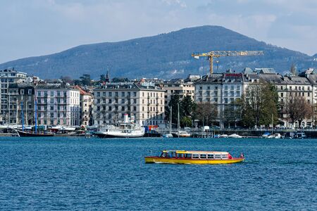 Geneva, Switzerland - April 14, 2019: View on Geneva lake, far away mountains and city Geneva - imageのeditorial素材