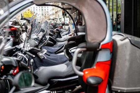 Geneva, Switzerland - April 14, 2019: A row of scooters parked along the street. Side view - image