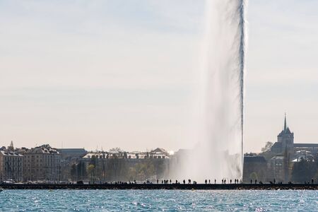Geneva, Switzerland - April 15, 2019: Lake of Geneva with its Jet d.Eau or large fountain spraying...
