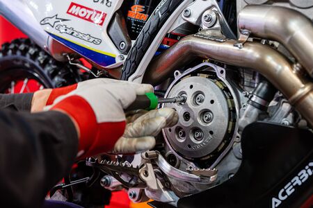 Riga, Latvia - April 12, 2019:  A mechanic in a workshop repairs a sports motorcycle - mimageのeditorial素材