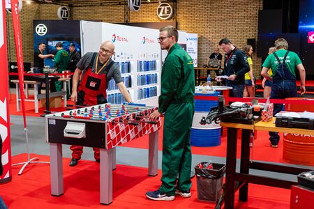 Riga, Latvia - April 12, 2019: Mechanics play board games in the workshop lounge - image