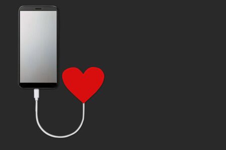 concept of the power of love, on dark background  isolated Mobile smart phone with blank screen that is charging from red heart, flat layの写真素材