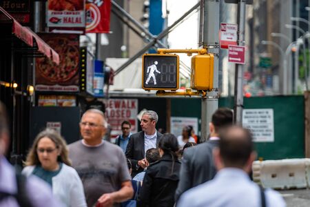 New York City, USA - June 6, 2019: People crossing the street at a busy intersection in Manhattanのeditorial素材