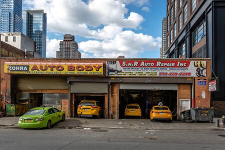 Manhattan, New York City, USA - June 6, 2019: Several taxis at car repair shop