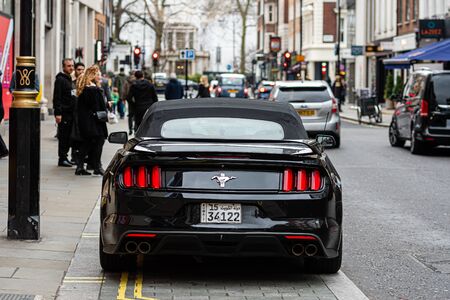 London, England, UK - January 2, 2020: a black, expensive sports muscle car parked on the edge of a city streetのeditorial素材