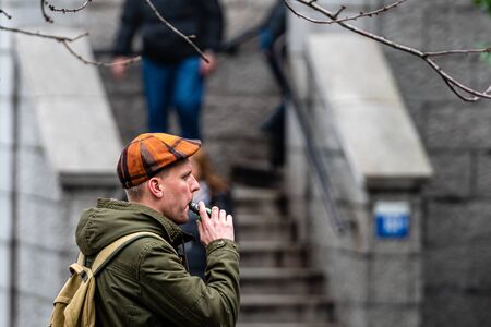 London, England, UK - January 3, 2020: a man smokes an electronic cigarette on the streetのeditorial素材