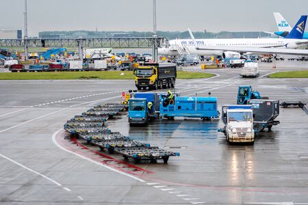 Amsterdam, Netherlands - June 5, 2019: Baggage tractors and service truck at  the Amsterdam Schiphol Airportのeditorial素材